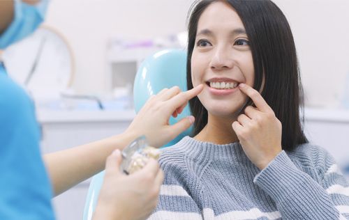 woman receives treatment from dental assistaint 