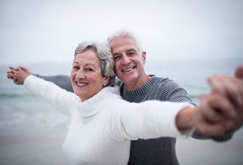 couple embracing and smiling on beach 