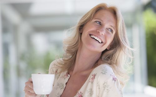 Woman smiling representing dental veneers