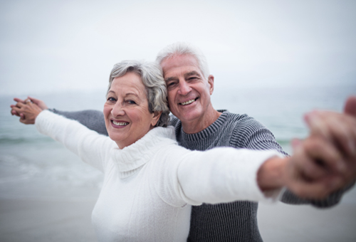 couple embracing and smiling on beach