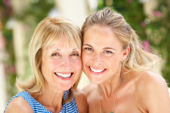 blonde mother and daughter smiling