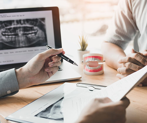 marco island dentist with chart and dentures